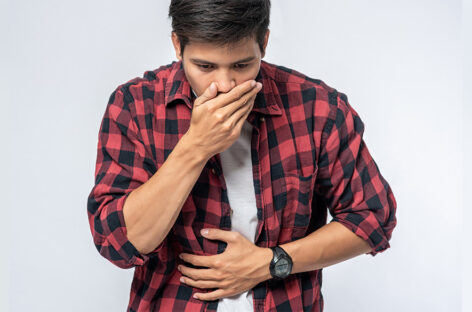 What causes a person to vomit blood?