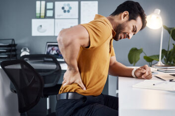 When did back pain become part of having a desk job?