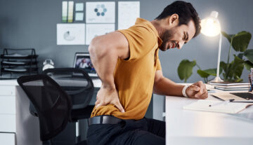When did back pain become part of having a desk job?